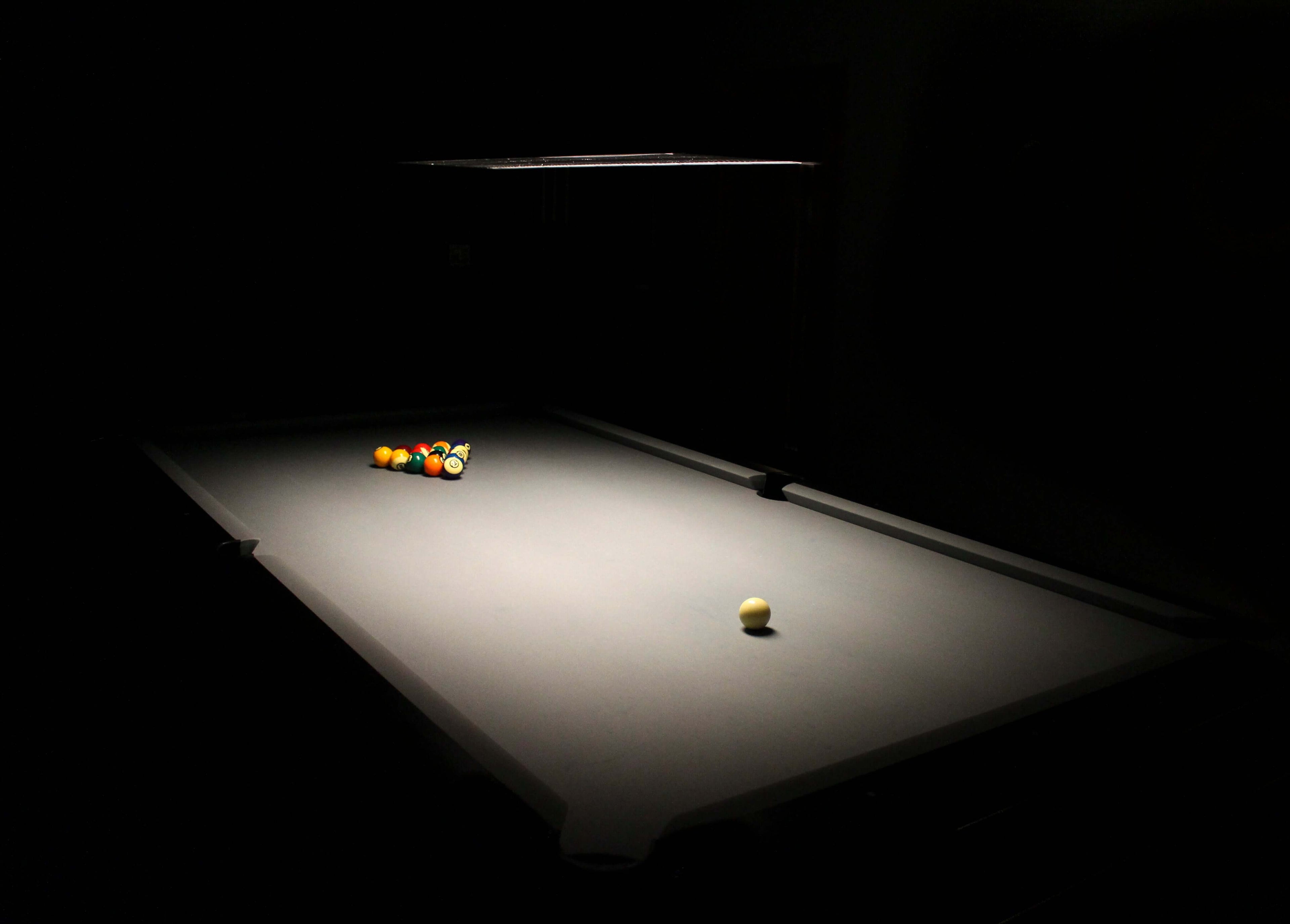 dark pool table with just enough light to see the rack