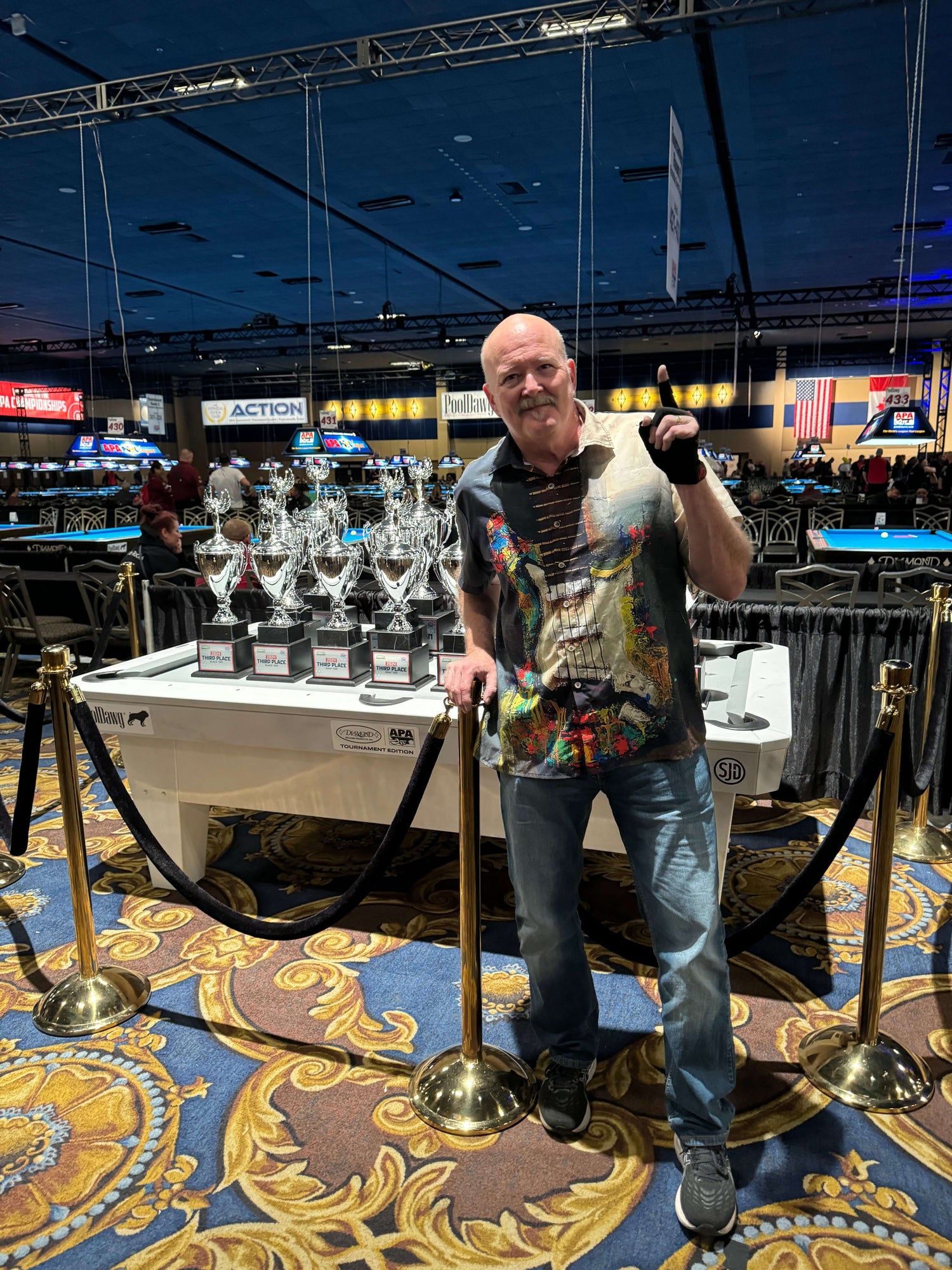 Don Campbell next to trophies at APA World Pool Player Championships