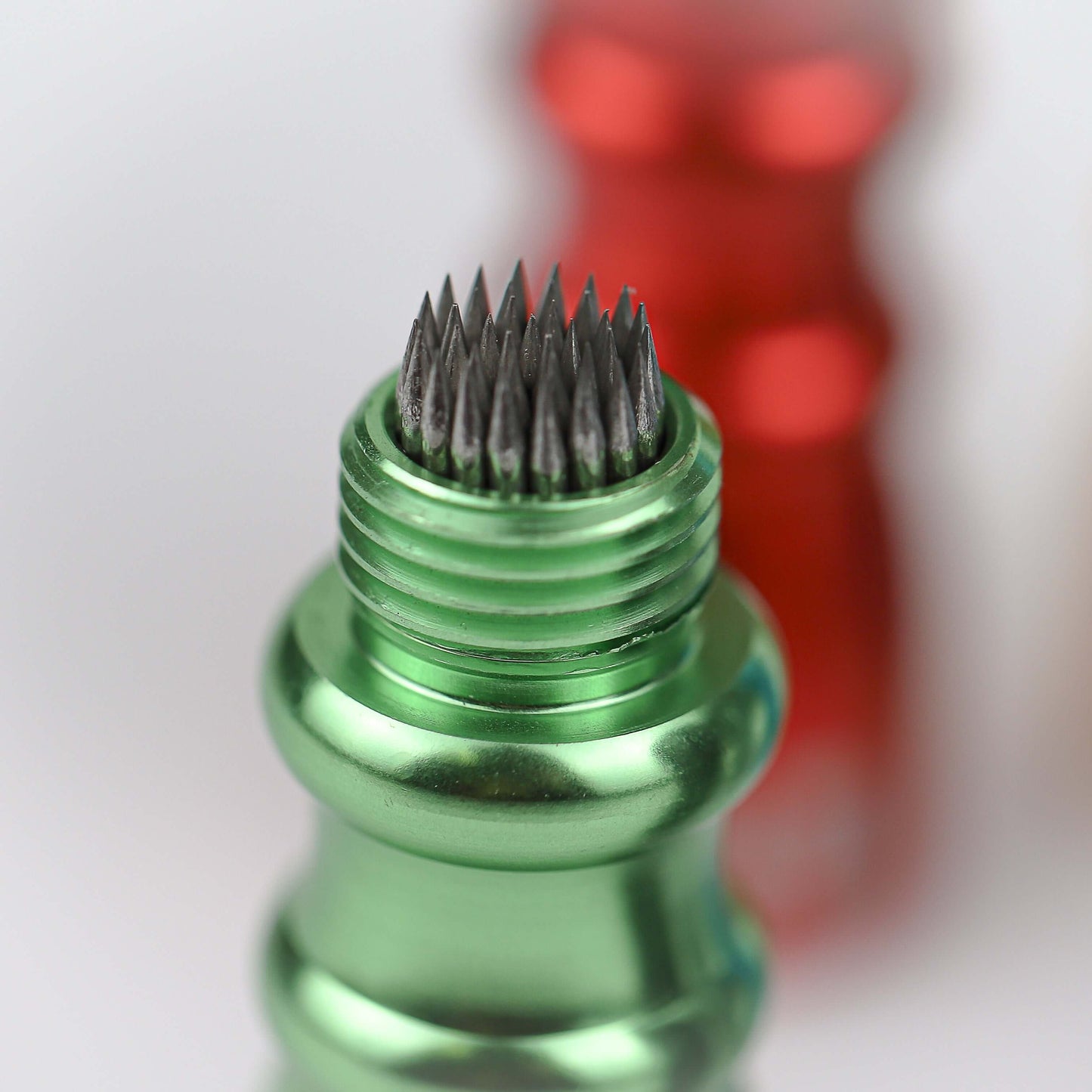 Green cue shaper showing the pointed prongs